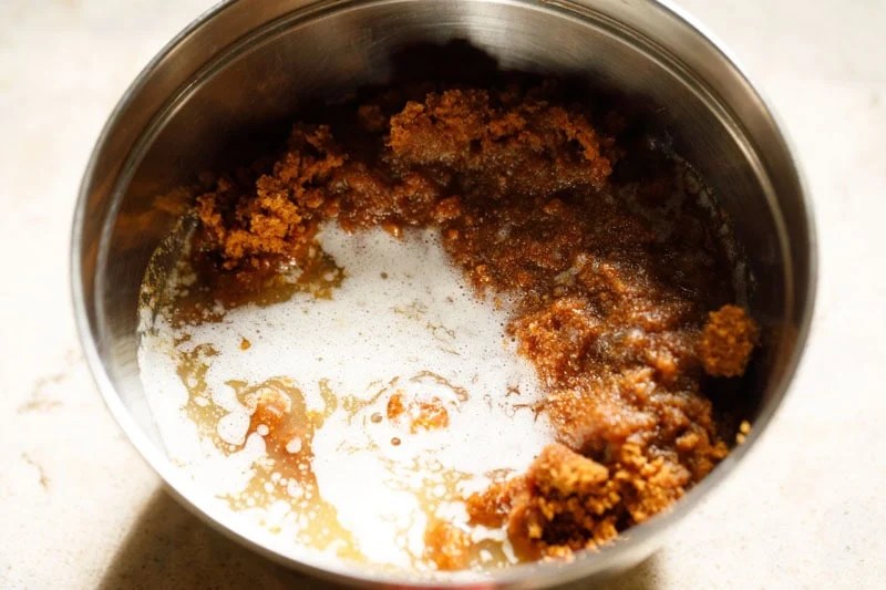 Crushed biscoff cookies and melted butter in a bowl.