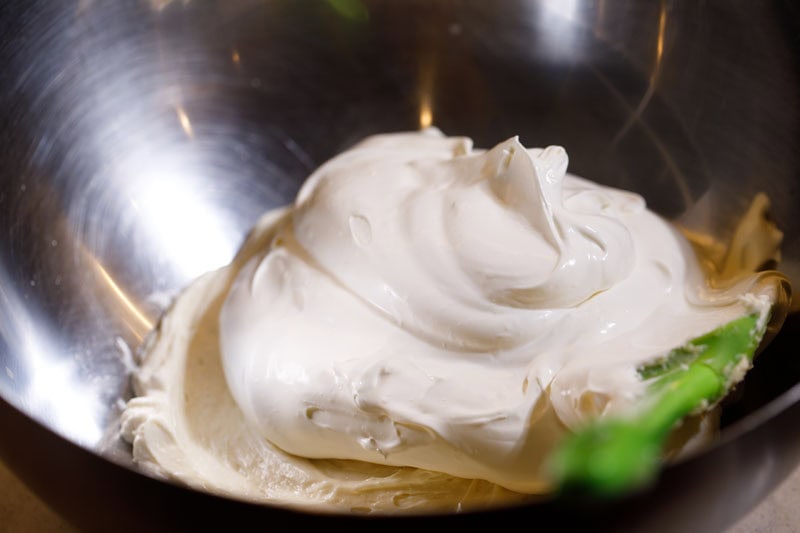 Whipped cream and whipped cream cheese in bowl.