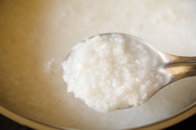 Well cooked and softened ada in a spoon.