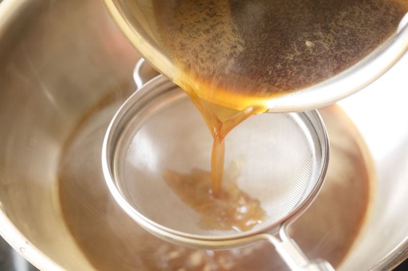 Straining jaggery syrup.