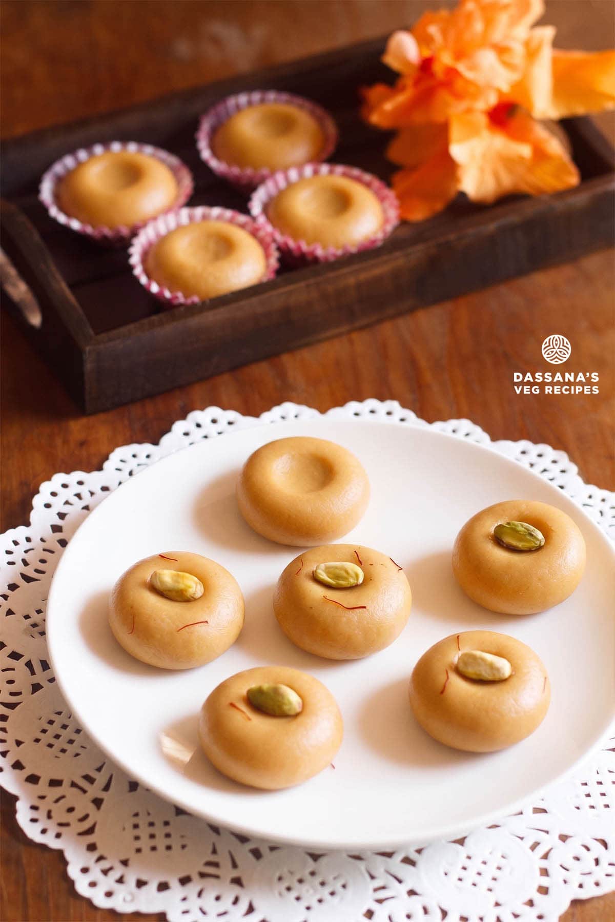 Plate of mawa peda garnished with pistachios.