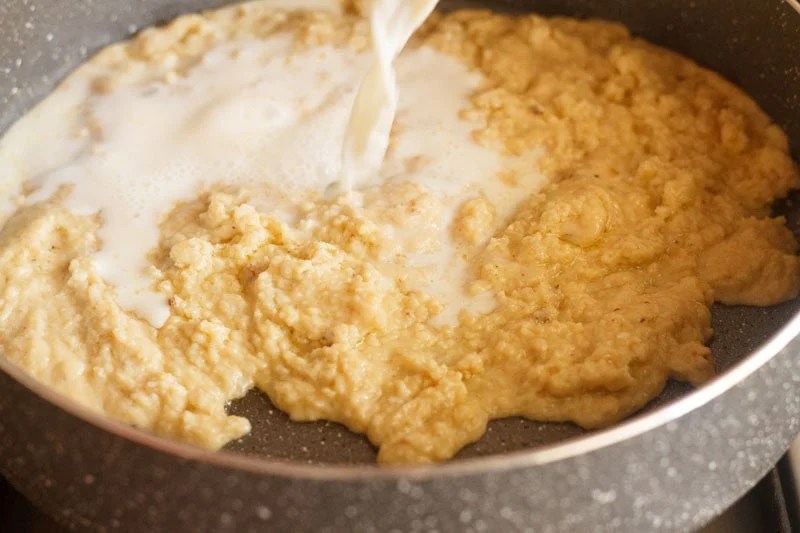 Milk being poured in pan.