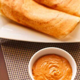 Onion tomato chutney in a bowl with text layovers.