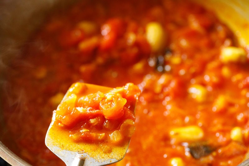 Softened tomatoes over a flat spatula.
