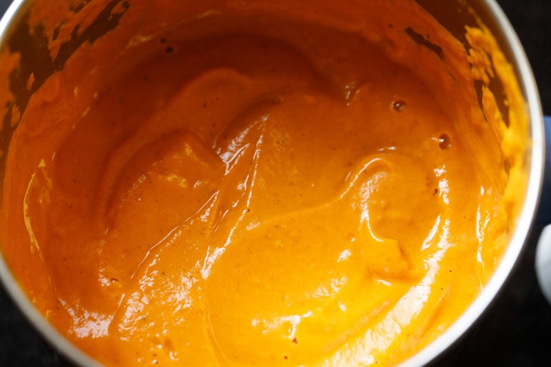Smooth and finely blended onion tomato cashew paste in pan.