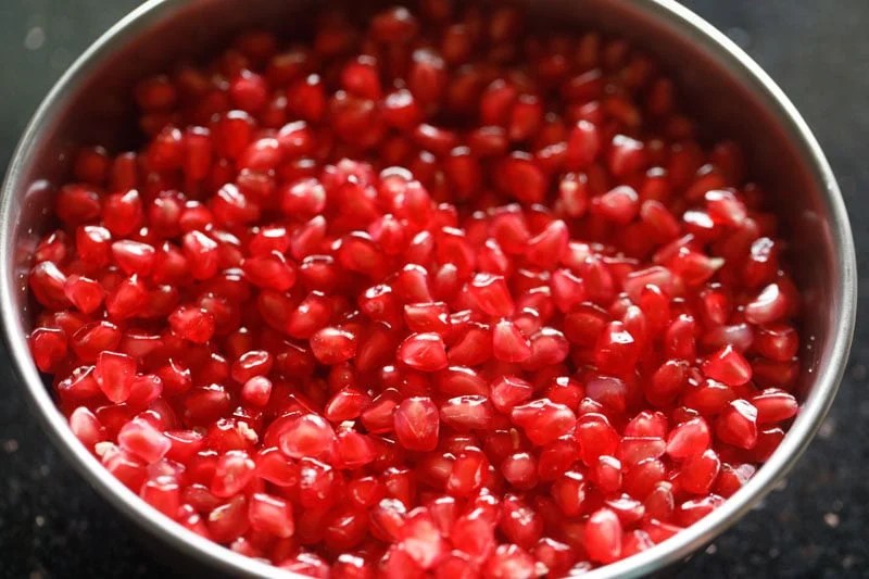 Bowl of vibrant pomegranate arils.