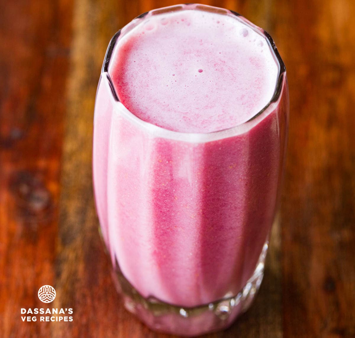 Pomegranate juice in a tall decorative glass.