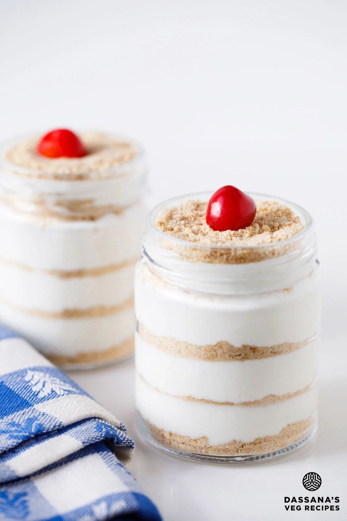 Serradura dessert in glass jars with cherry topping.