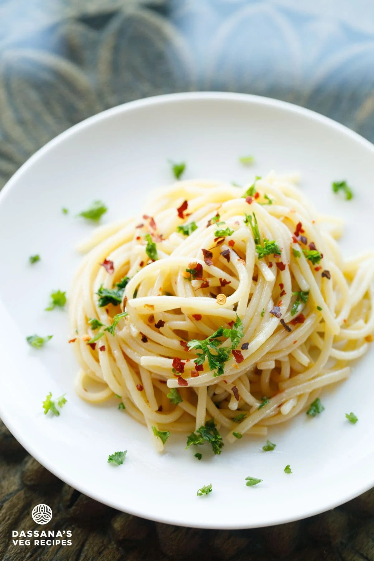 Plate of spaghetti aglio e olio with herbs.